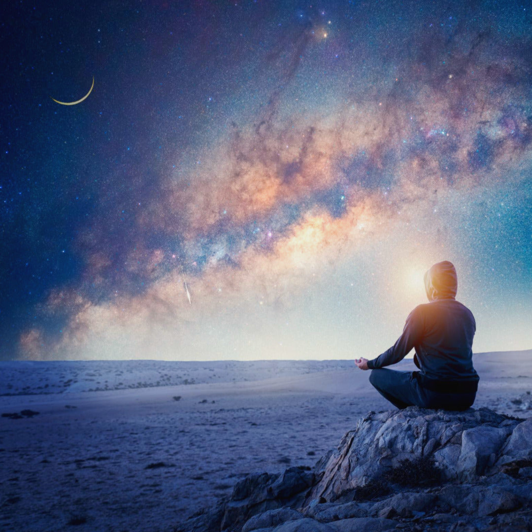 A person meditating during a starry night sky. Expressing the reason of why spirituality is important.