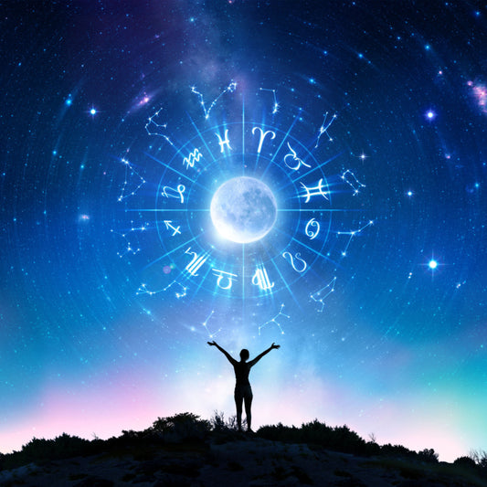 A person raising their arms as they intertwine their spirituality and astrology together.